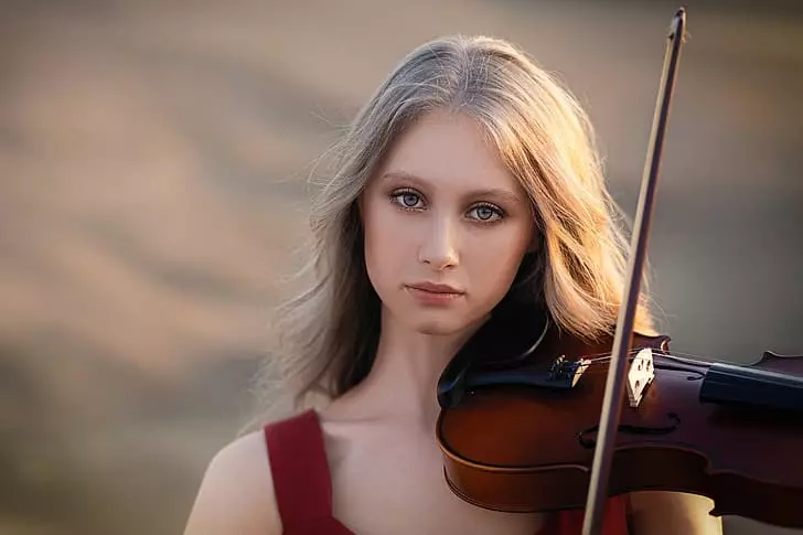 a girl violinist with blond hair
